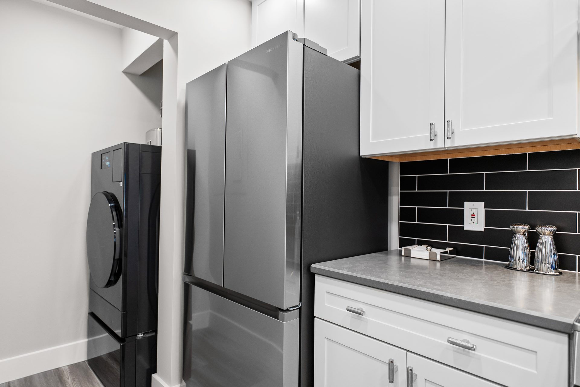 In-unit stacked laundry alongside the renovated kitchen cabinetry