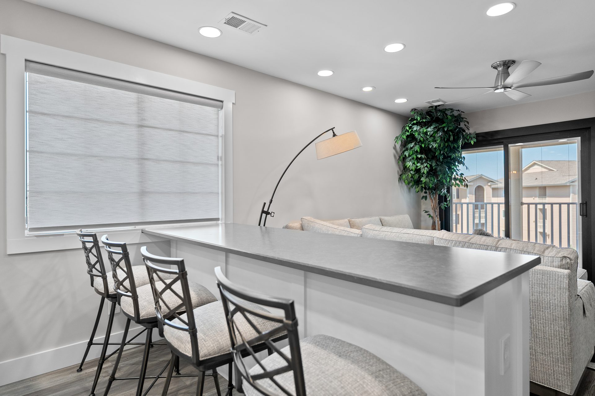 Renovated living area with new luxury vinyl plank flooring and balcony access