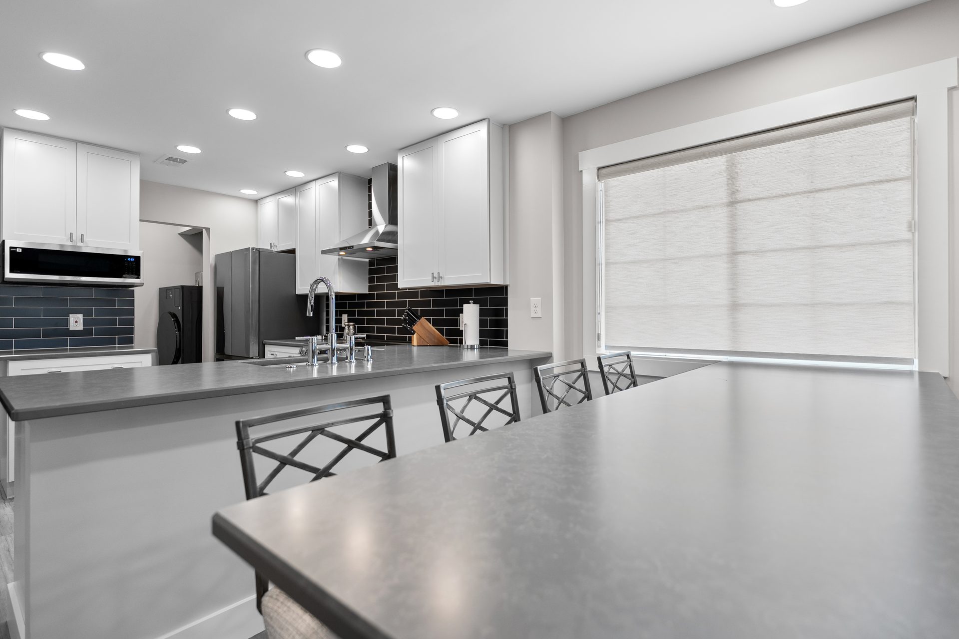 Open-concept kitchen and dining bar with counter seating after renovation